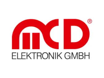 The image features the logo for MCD Elektronik GmbH, prominently displaying the letters "mcd" in bold red typography, accompanied by the text "ELEKTRONIK GMBH" in a smaller black font below. The design emphasizes a modern and professional appearance.
