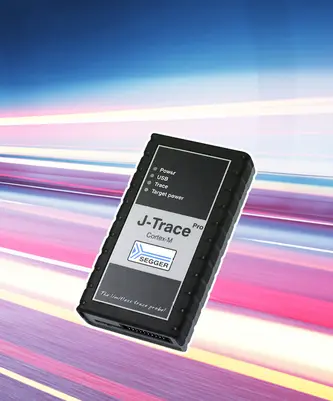 Image of a black device labeled "J-Trace Pro Cortex-M" with indicators for Power, USB, Trace, and Target power. The background features a dynamic, blurred effect, suggesting speed or technology. The device is used for debugging and tracing in embedded systems.