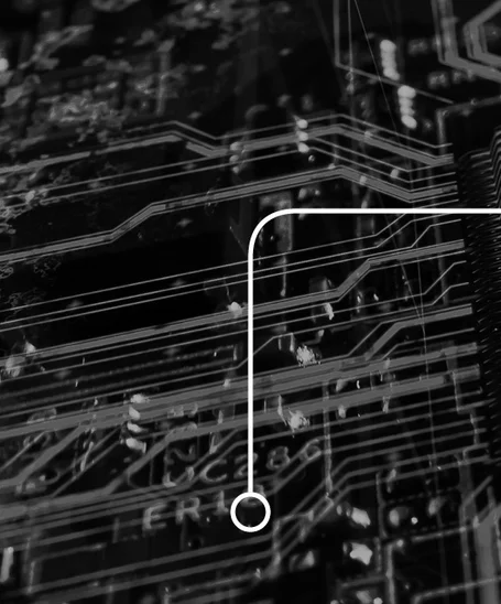 A close-up view of a black circuit board featuring intricate pathways and connections. A white curved line connects two points, highlighting the flow of electrical signals. The image emphasizes the complexity of technology and the design of electronic components.