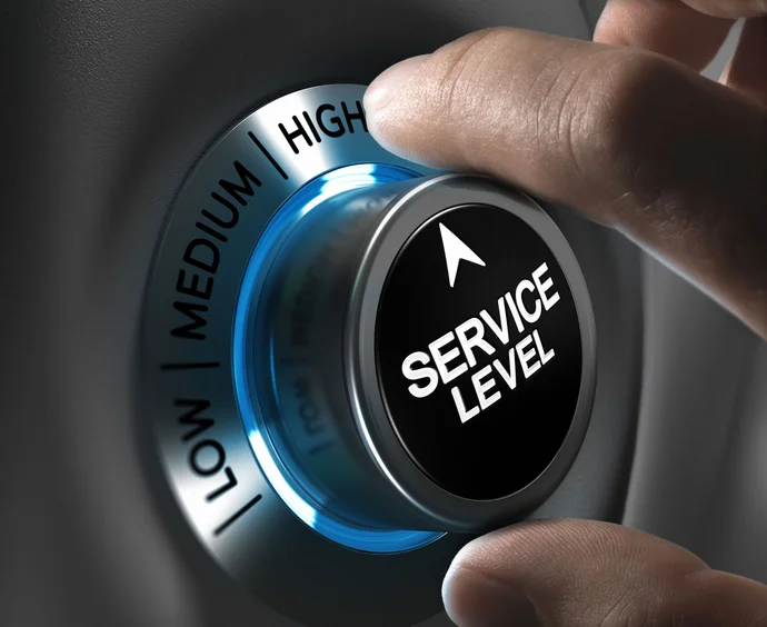 A close-up image of a hand turning a dial labeled "SERVICE LEVEL," with settings for "LOW," "MEDIUM," and "HIGH." The dial emits a blue glow, signifying interaction and adjustment.