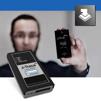 A person holds a small device labeled "J-Link" in one hand, while a larger device labeled "J-Trace" is in the foreground. The background features a blurred figure, emphasizing the devices used for debugging and programming in embedded systems.