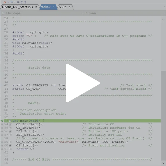 The image displays a code snippet in a programming environment, showcasing parts of a C/C++ program. Key elements include function definitions, initialization of the operating system, and task management code. A play icon indicates it may be part of a tutorial or instructional video.