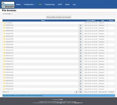 A file browser interface displaying various modules listed in a directory format. Each module is labeled with a name like "MODULE.001" through "MODULE.024," along with a timestamp for last modification and directory designation. A tip about file uploads via drag and drop is also visible.