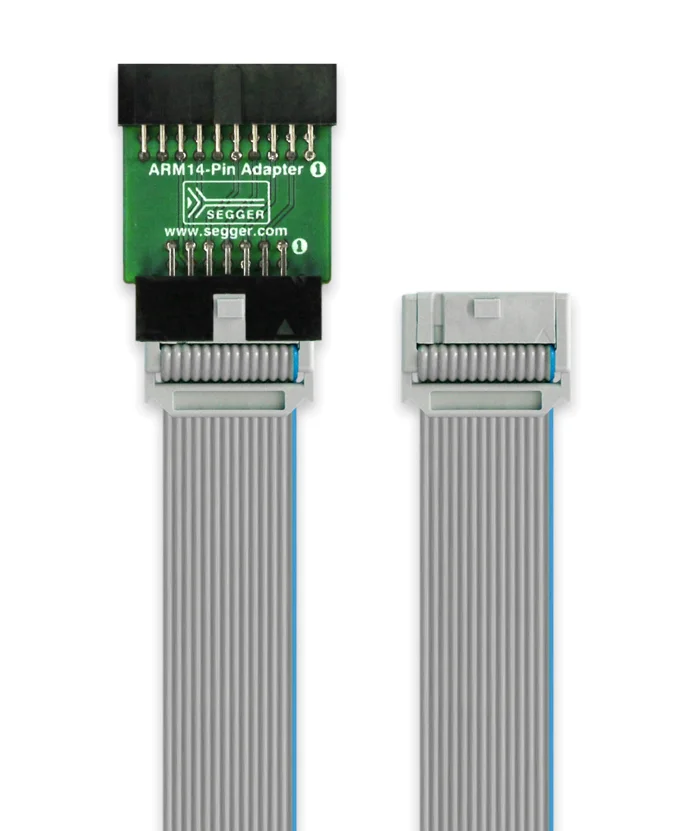 An ARM14-pin adapter with a green circuit board on top, featuring pin connectors. It is connected to a gray ribbon cable that has two connectors at either end. The adapter is for interfacing with ARM devices in electronic projects.