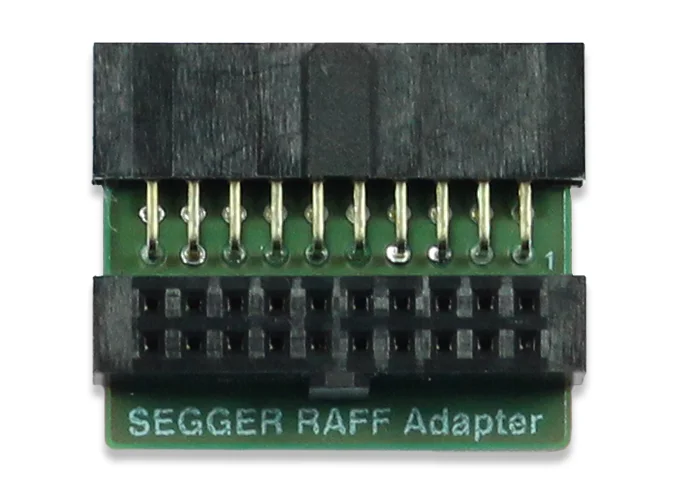 Image of a SEGGER RAFF Adapter. It features a small green circuit board with two rows of metal pins on top and a black connector at the bottom. The text "SEGGER RAFF Adapter" is printed on the board, indicating its purpose for hardware connections.
