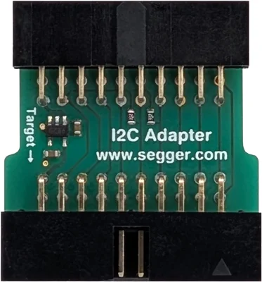 The image shows an I2C adapter circuit board with a green background. It has a row of pins on one side and printed text that includes "I2C Adapter" and "www.segger.com." There are also small electronic components visible on the board.
