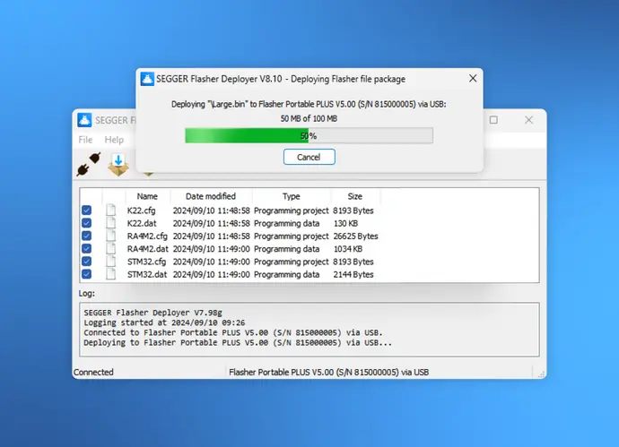 A computer interface is displaying the SEGGER Flasher Deployer software, showing a progress bar at 50% while deploying a file named "Large.bin" to a device. The log details connection to the Flasher Portable PLUS and lists multiple programming files with their sizes.