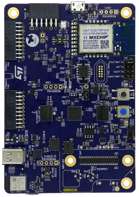 The image shows a blue printed circuit board (PCB) with multiple components, including microchips, resistors, and connectors. The board features labeled sections and ports, including a USB connection, and is designed for electronic applications. The manufacturer logo is visible at the top left.