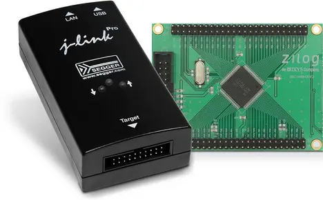 The image features a black SEGGER J-Link Pro debugging unit on the left, paired with a green Zilog development board on the right. The development board has visible circuitry, with a central microchip and multiple pin connectors along its edges.