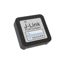 The image shows a compact J-Link PLUS device with a rectangular design. It features a white label displaying "J-Link PLUS Compact" and the SEGGER logo, which includes a stylized blue arrow. The device has multiple connection pins on one side.