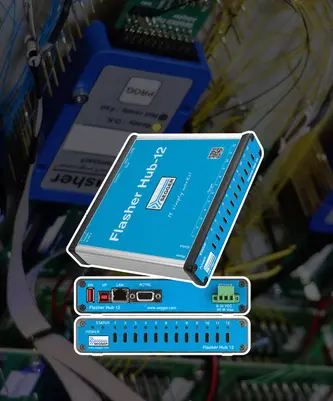 An image of the Flasher Hub-12, a blue device used for programming and debugging embedded systems. The hub features multiple ports on its front and back panels, including USB and LAN connections, and displays status indicators for power and activity.