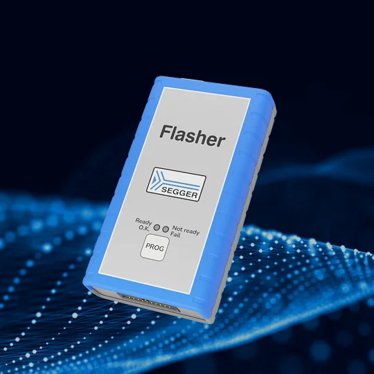 A blue and gray in-circuit programmer labeled "Flasher" is displayed. It features a logo for SEGGER and indicators for "Ready," "Not ready," and "Fail" status. The device is used for programming electronic circuits. The background has a digital design.