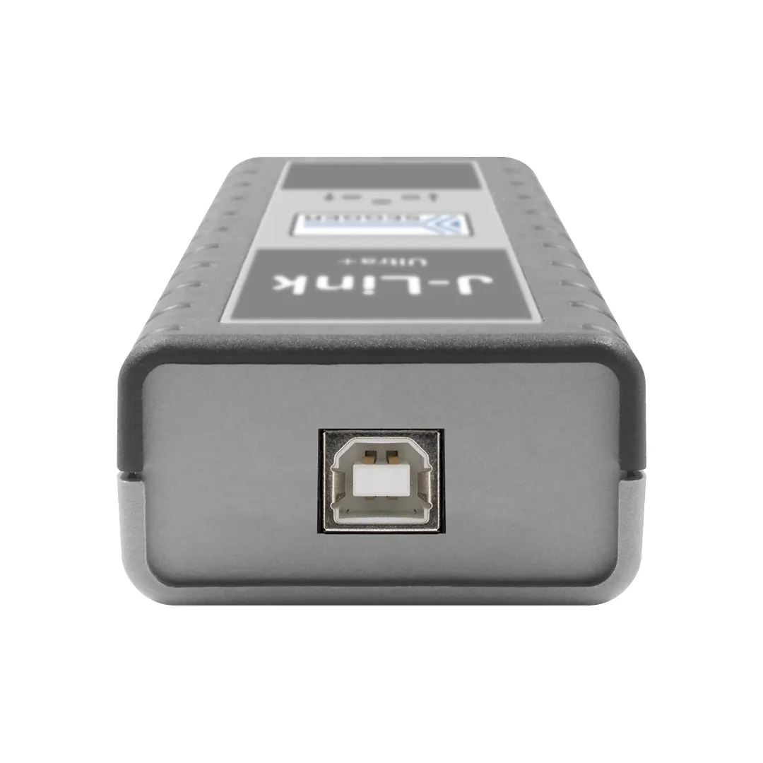 A gray electronic device with a rectangular shape. The front features a prominent USB port in the center and a label displaying "J-Link" and "Unit" above it. The device's surface has a textured grip, suggesting durability.