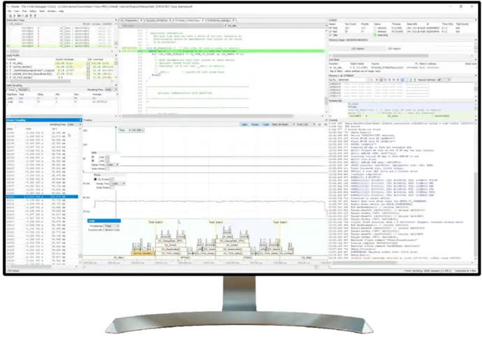 A computer monitor displays a programming interface featuring multiple windows for debugging and analyzing code. Key components include a code editor on the left, a power consumption graph, and various system diagnostics and log data. The layout suggests an environment for performance tracking and firmware development.