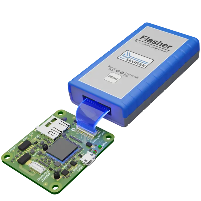 An electronic device is shown, featuring a blue and gray programmer labeled "Flasher" from SEGGER, connected via a cable to a green circuit board equipped with various components, including a microcontroller and interfaces. The setup is used for programming embedded systems.