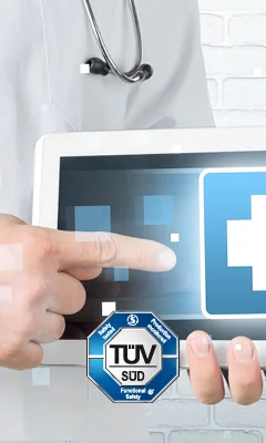 A healthcare professional in a white coat points to a tablet displaying a blue medical cross symbol. The TÜV SÜD certification logo is prominently featured at the bottom, indicating a focus on safety and functionality in healthcare technology.