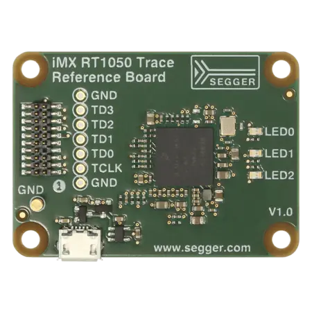 The image shows an i.MX RT1050 Trace Reference Board, featuring a green circuit board with various electronic components. It includes a microchip at the center, multiple connectors labeled GND and TD0-3, and several small LEDs. The board is designed for electronic prototyping and development.